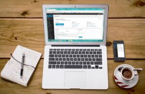 Working with data in WordPress on a laptop with a cup of coffee